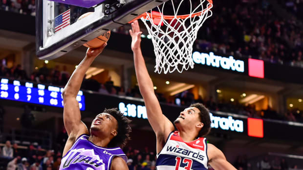 Utah Jazz guard Collin Sexton (2) takes a shot around Washington Wizards guard Jordan Poole (13) during the second half at the Delta Center.